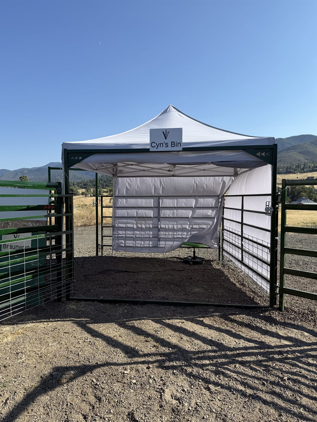 Donor sign reading Cyn's Bin on the shaded holding pen